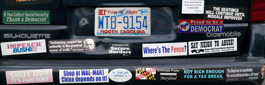 Back of a car covered in bumper stickers