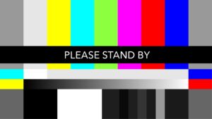 A multi-colored test screen says Please Stand By. Next Stage is disrupting your regularly scheduled programming to bring you the Seven Vital Conditions for Health and Well-being